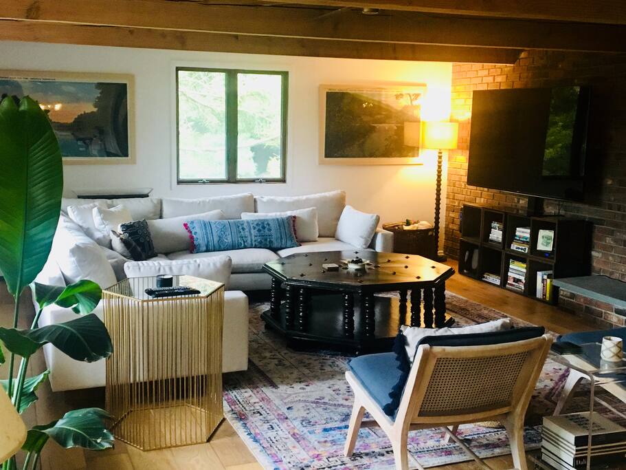 living room with large TV and wood burning fireplace