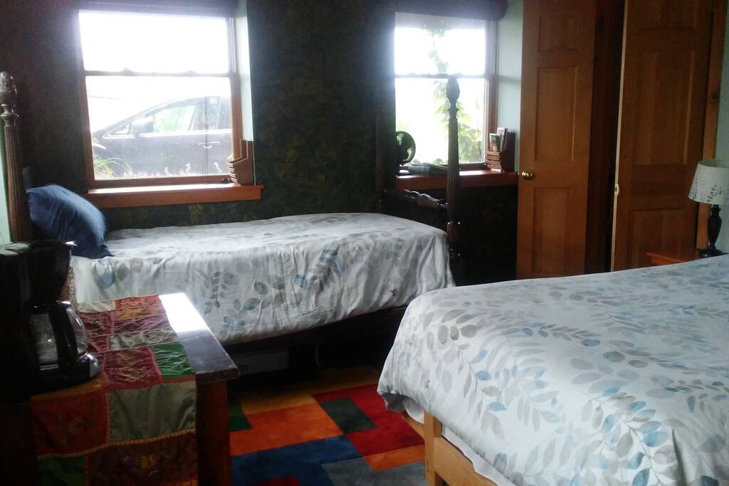 A single bed in the room as well as a double bed.