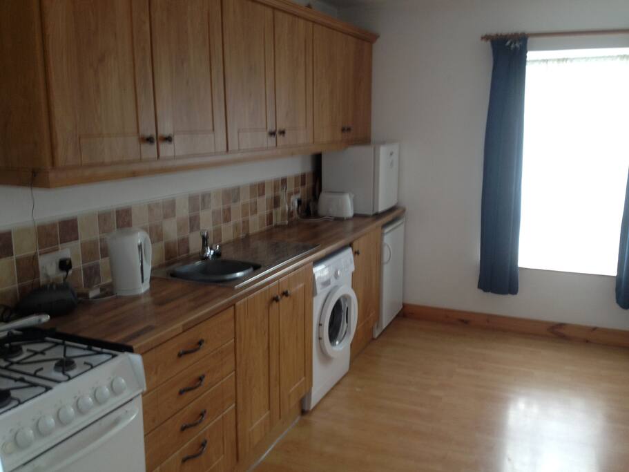 The kitchen contains a washing machine, gas cooker, fridge & everything you need for self catering