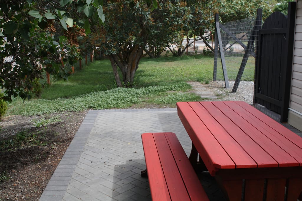 Patio leads to fenced in yard for kids or dogs.