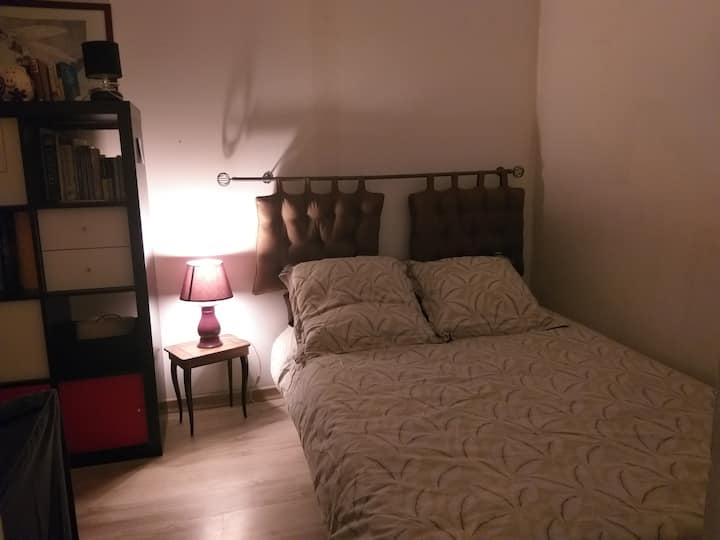The small bedroom on a garden with a double bed and storage