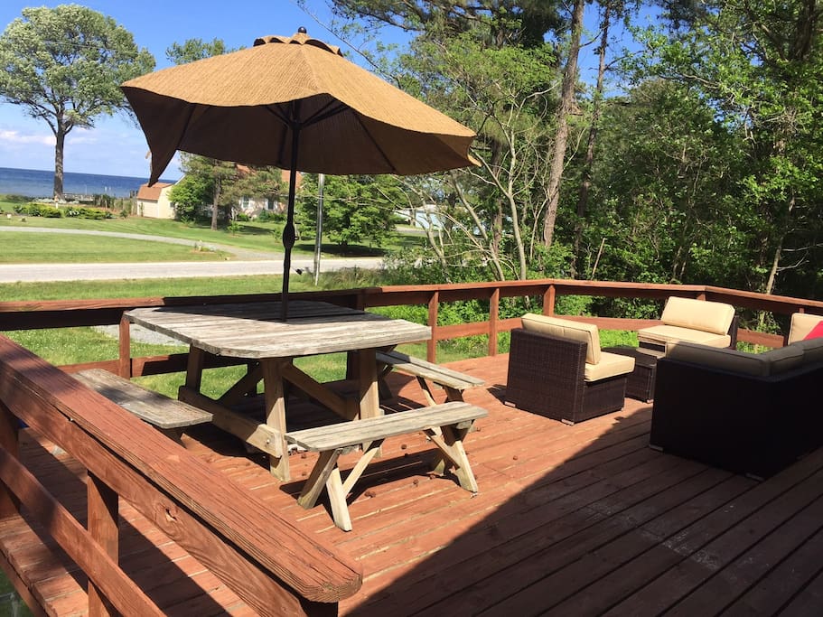 Deck with lounge seating & picnic table for enjoying the water view