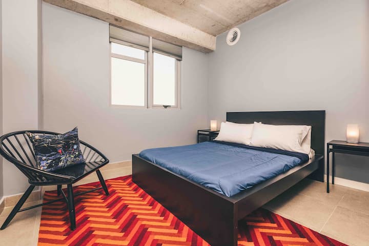 Third bedroom with queen size bed and a view of the ocean.
