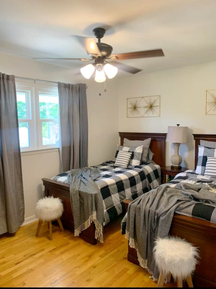 Bedroom 3 with two twin beds and blackout curtains. 