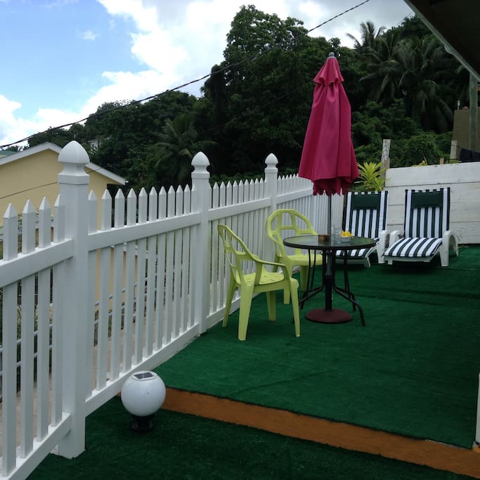 Terrace with sun lounger , umbrella