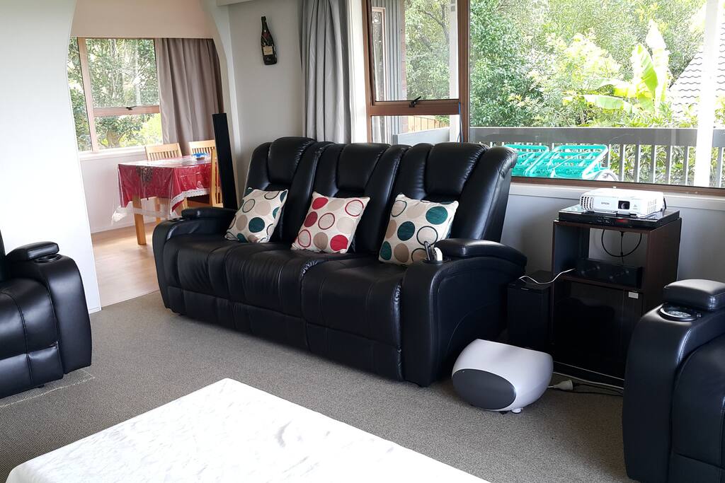 Living room with a cinema-like seat recliners.