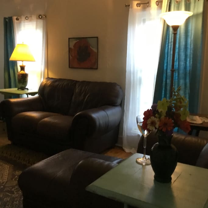 Classy and comfortable Natuzzi Italian leather and fresh flowers from the garden await you