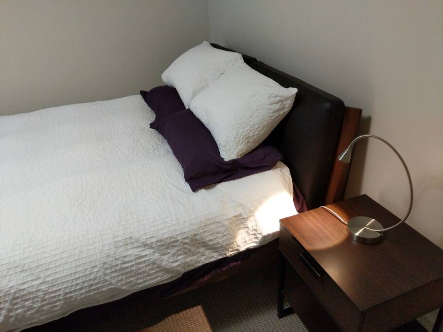basement bedroom. queen bed. 4 pillows and comfortable mattress.