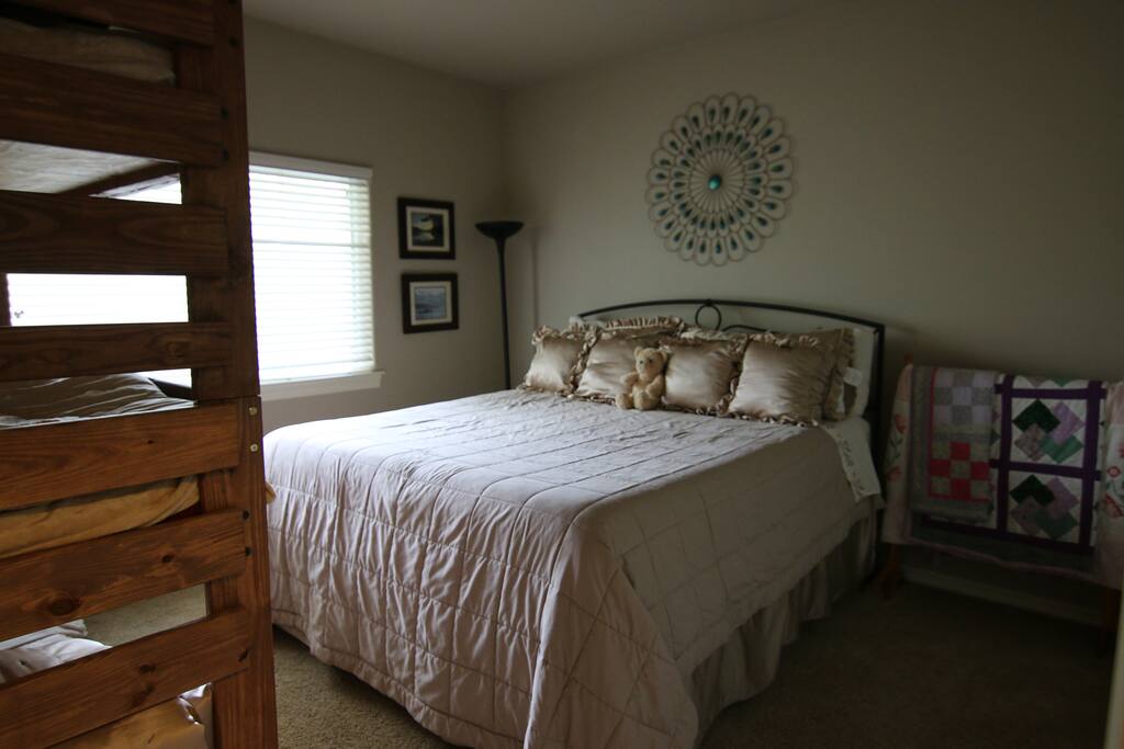 This bedroom sleeps 5. Cal King and a triple bunk bed.