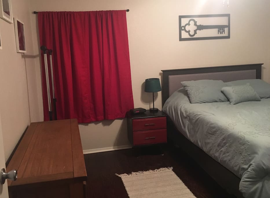 Large bedroom includes clothing rack