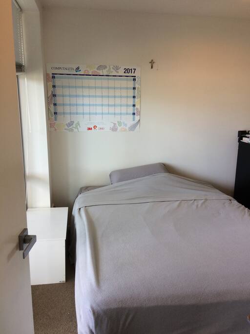 Queen sized bed with a drawer and a closet