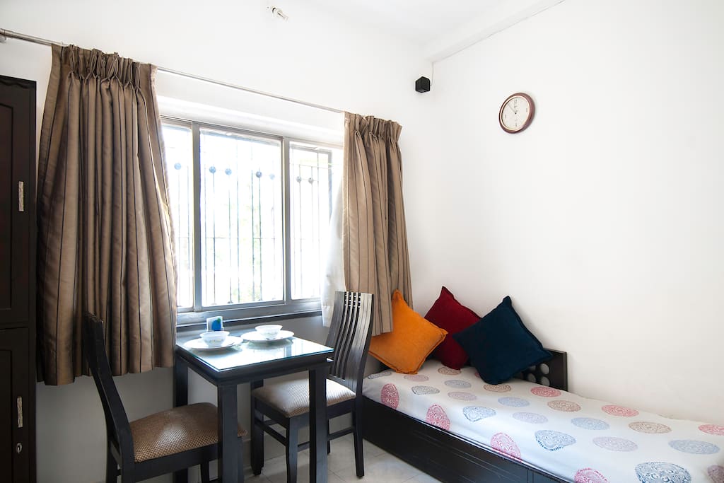 Abundant sunlight in the room with a dining table for two. The cot can be opened up in a double bed that accomodates two
