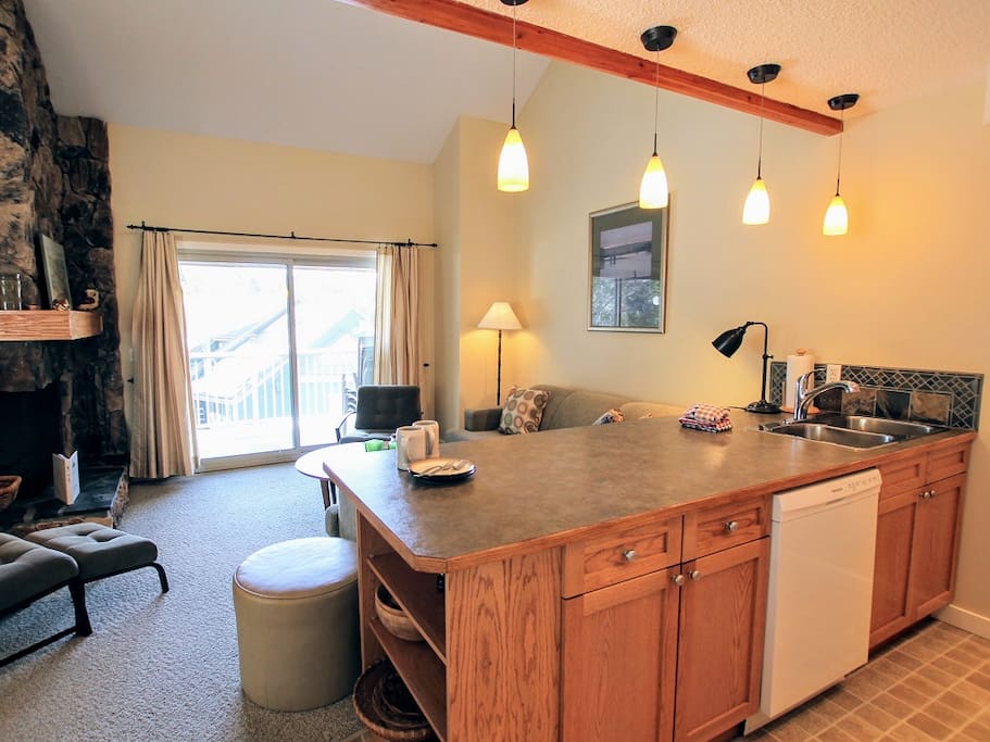 Fully Equipped Kitchen Open to Sitting Area with Wood Fireplace