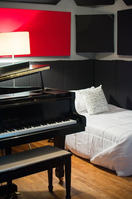 Tracking room with grand piano and fold-out futon with comfortable twin sized mattress topper.