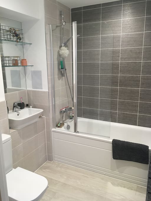 Pristine brand new bathroom, with bath and shower.