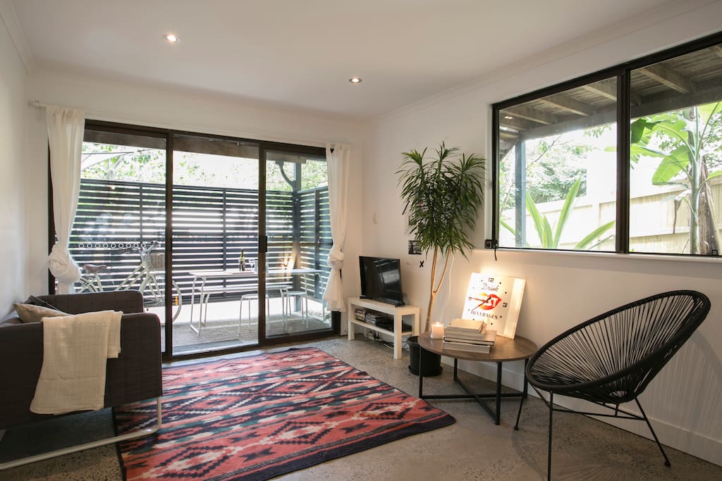 Newly renovated apartment. Living room featuring polished concrete floors. Enjoy the television with Netflix.
