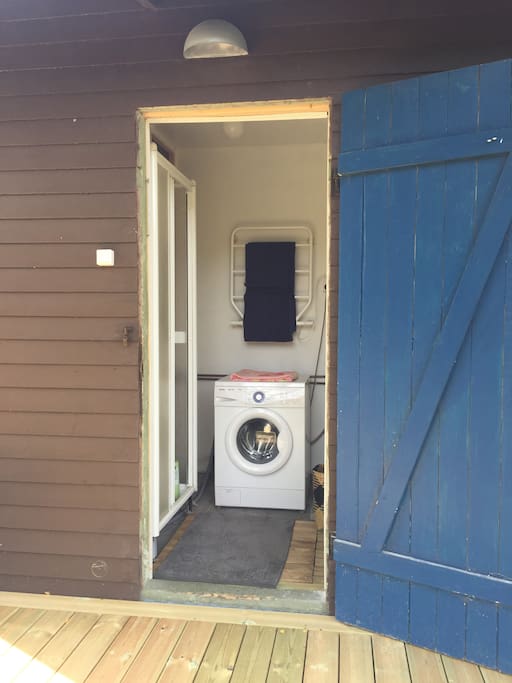 Separate semi outdoor shower and washer room with entrance from the deck