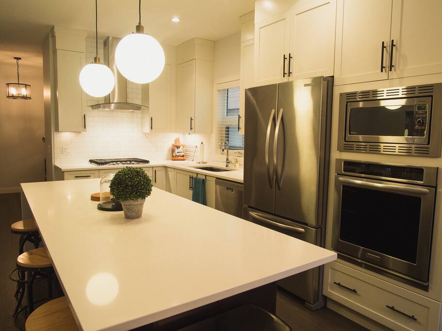 Chef's kitchen with 5 burner gas stove.