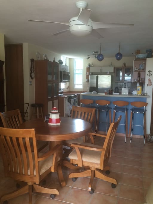 Fully equipped kitchen with stainless steel appliances and sitting for 8
