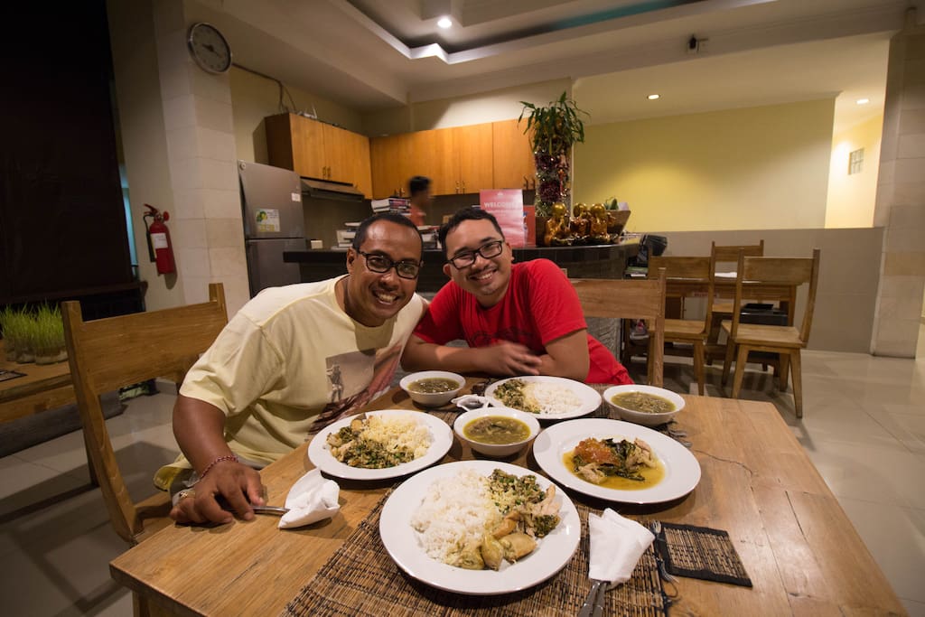 Pak Puspa is our onsite host and Balinese insider. We're eating a local speciality, Balinese roast pig in his home.
