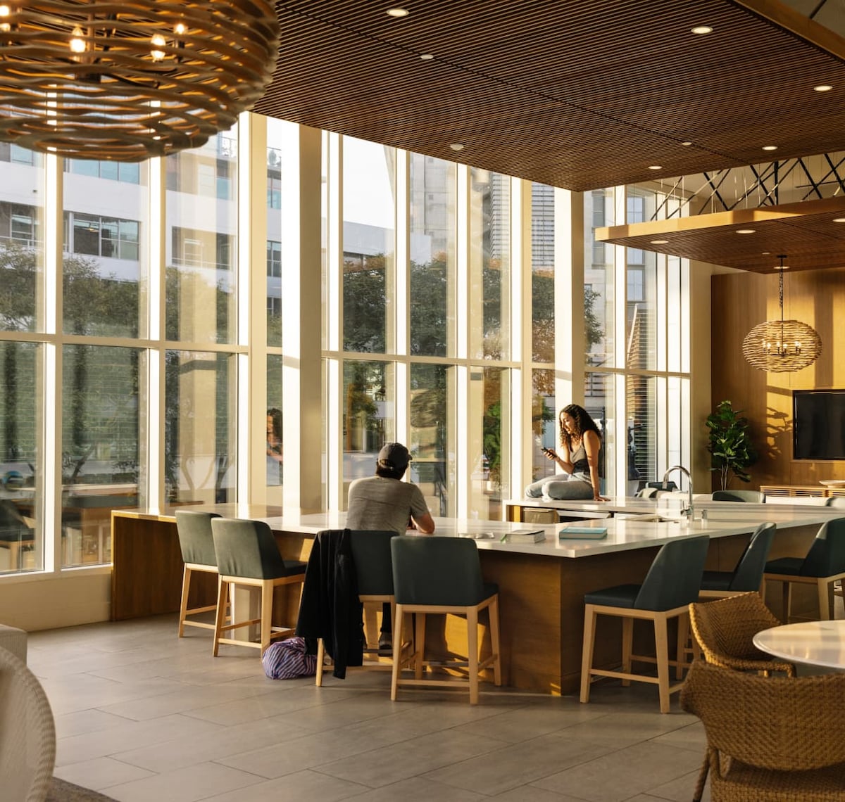 Image of two people hanging out in a communal apartment workspace