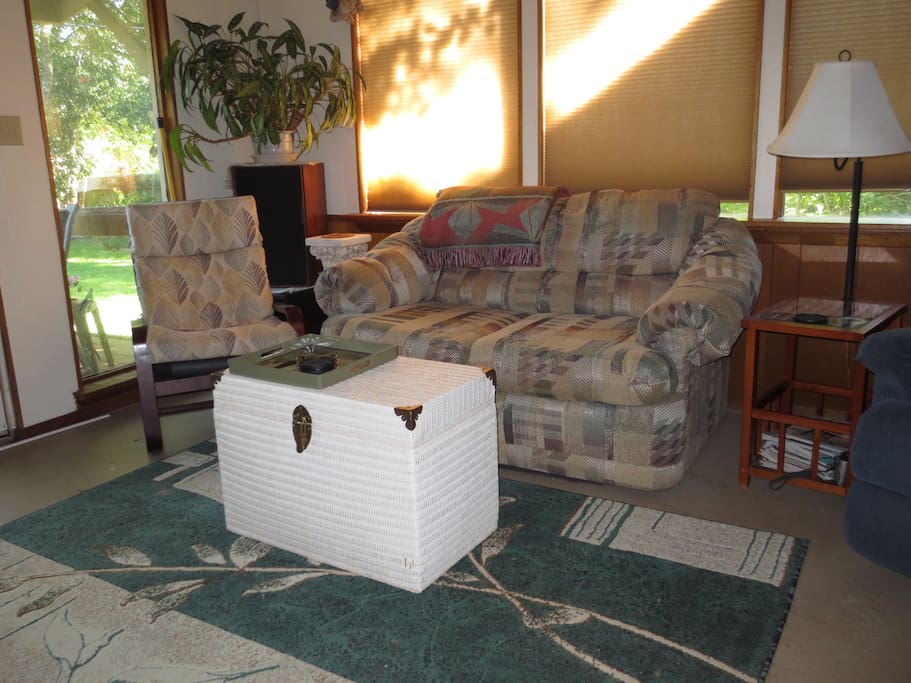 Den with wall of windows, opens on to deck