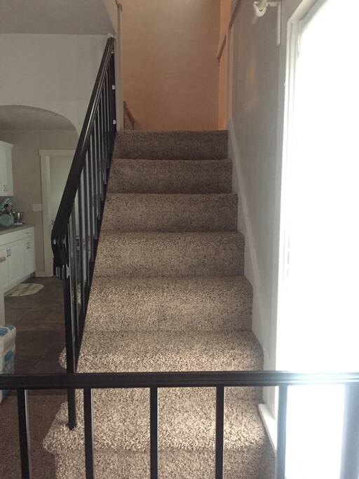 From the staircase you can see into the living room and kitchen