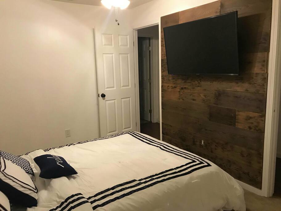 Main room with a new queen bed and ceiling fan