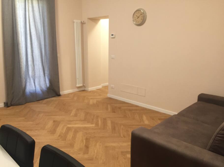 Living room with 2 sofabeds, table, chairs, Air Conditioner, window, TV, WIFI