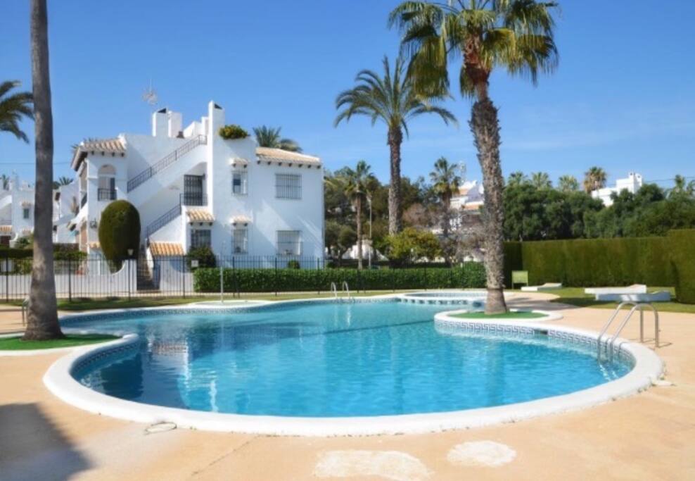 The tranquil communal pool is close to the bungalow.