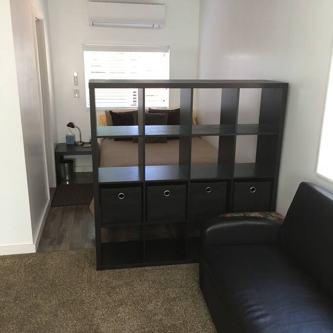 Bedroom area behind shelf unit
