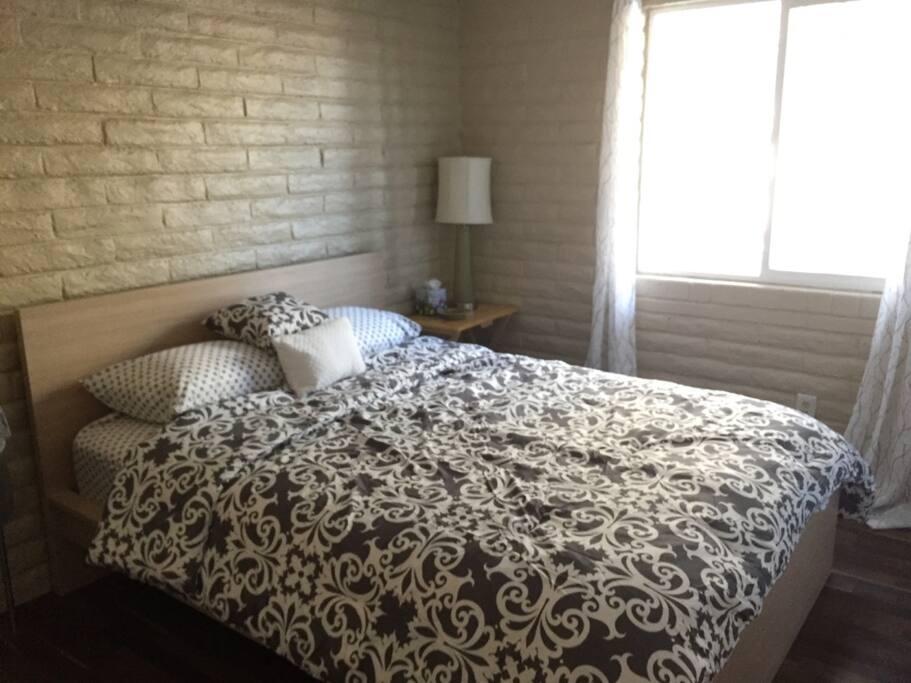 The Olive Room-view of the olive tree-comfy pillows, comforter, and towels on towel rack