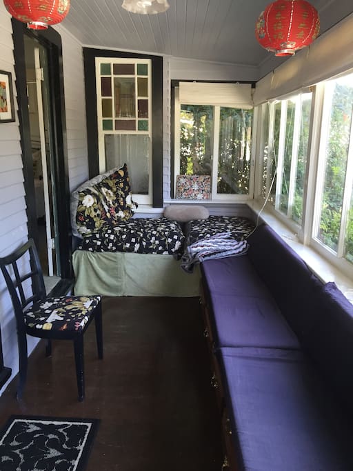 Glassed in front porch window with 15' of seats
