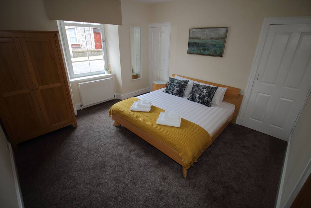 Master bedroom with Super kingsize bed and lots of storage.