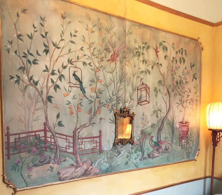 The chinoiserie mural on the bedroom wall