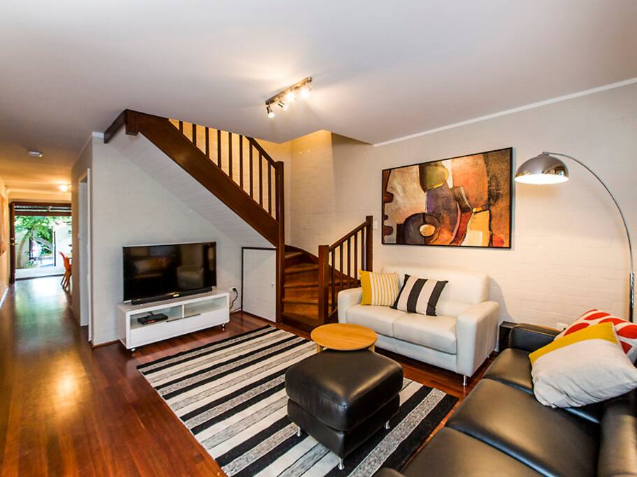 Well set up sitting area showing stairs to
bedroom area.
