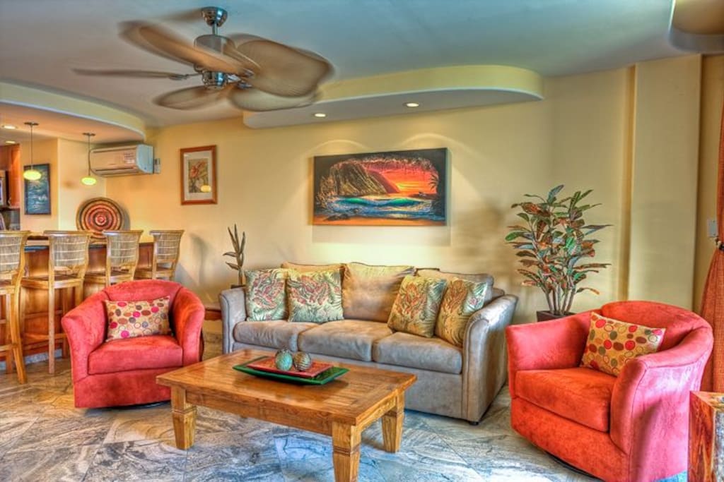 The living room. Note the travertine floor and the original Hawaiian Giclee.