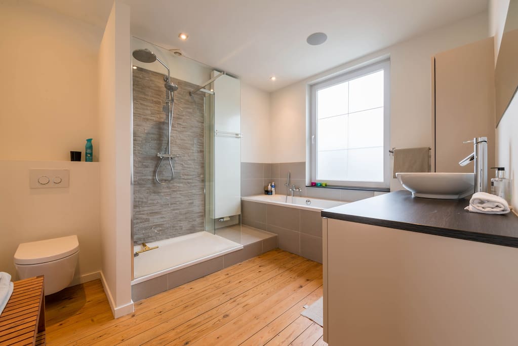 ruime badkamer met ligbad en douche