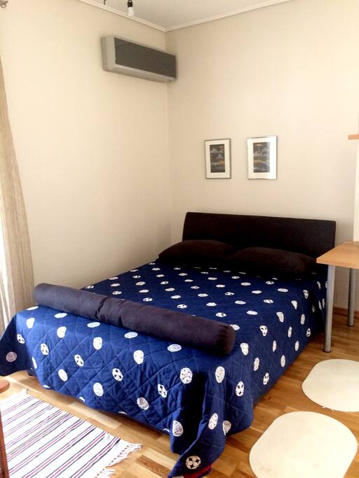 The master bedroom with a double bed, an office desk, a big wardrobe and access to the side and back terraces