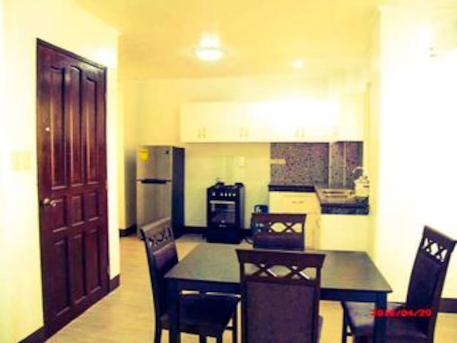 dining area, kitchen with full size fridge and stove with oven. granite counters in all!