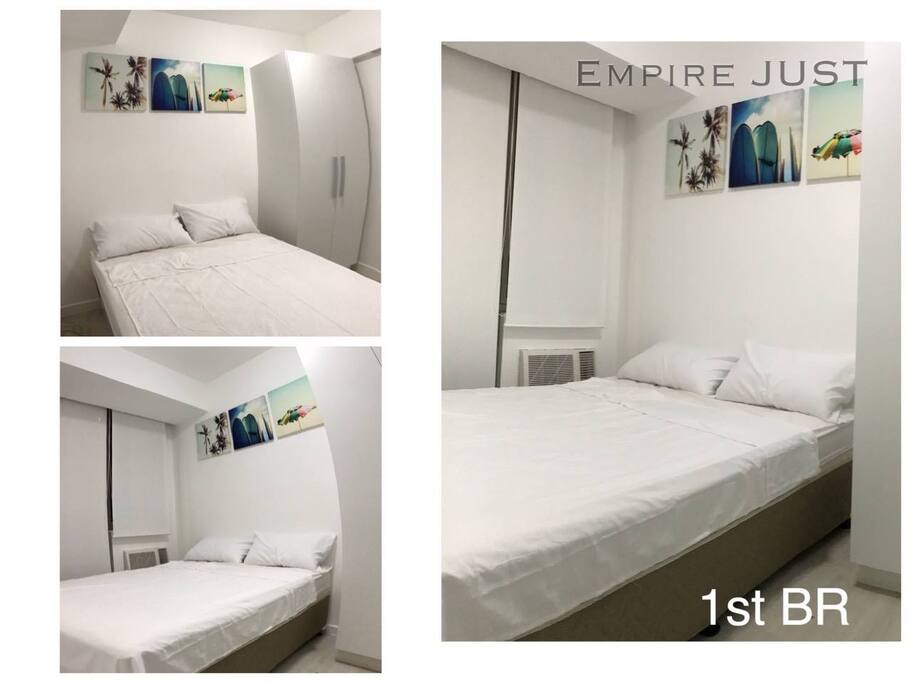 White colored 1st bedroom, Queen size bed.