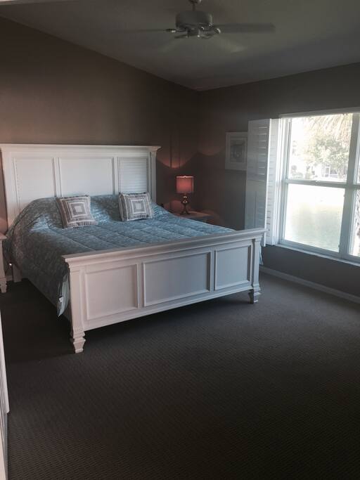 Main bedroom overlooking lake with king size bed