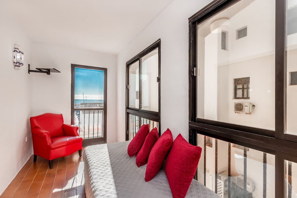 Covered terrace with seating area and sea views of Puerto Banus