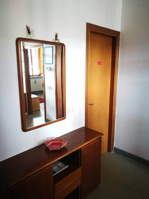 The left side of the entrance, with the door of the bathroom and the laundry room