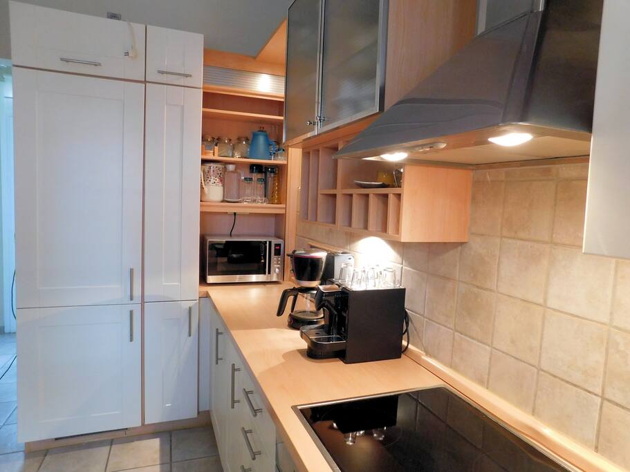 Two coffee makers, microwave and fridge