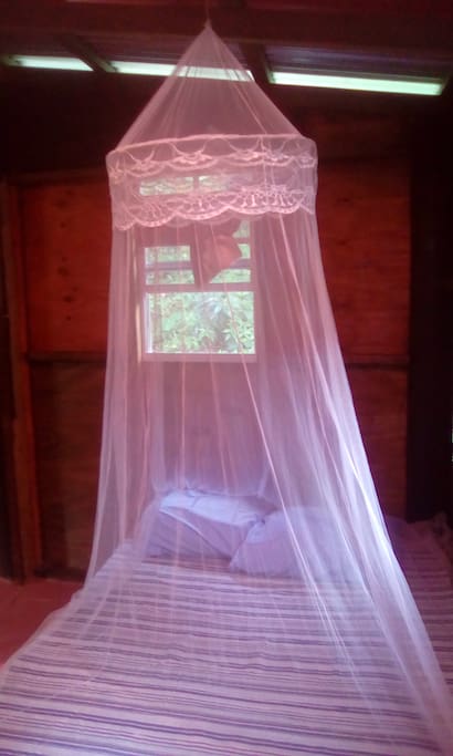 BED WITH MOSQUITO NET,BREADFRUIT ROOM
