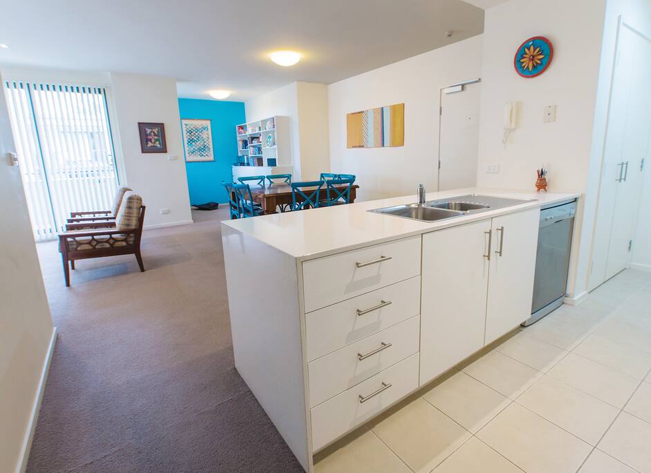 View across the kitchen to dining area and study nook. Cupboard on the far right is the laundry.