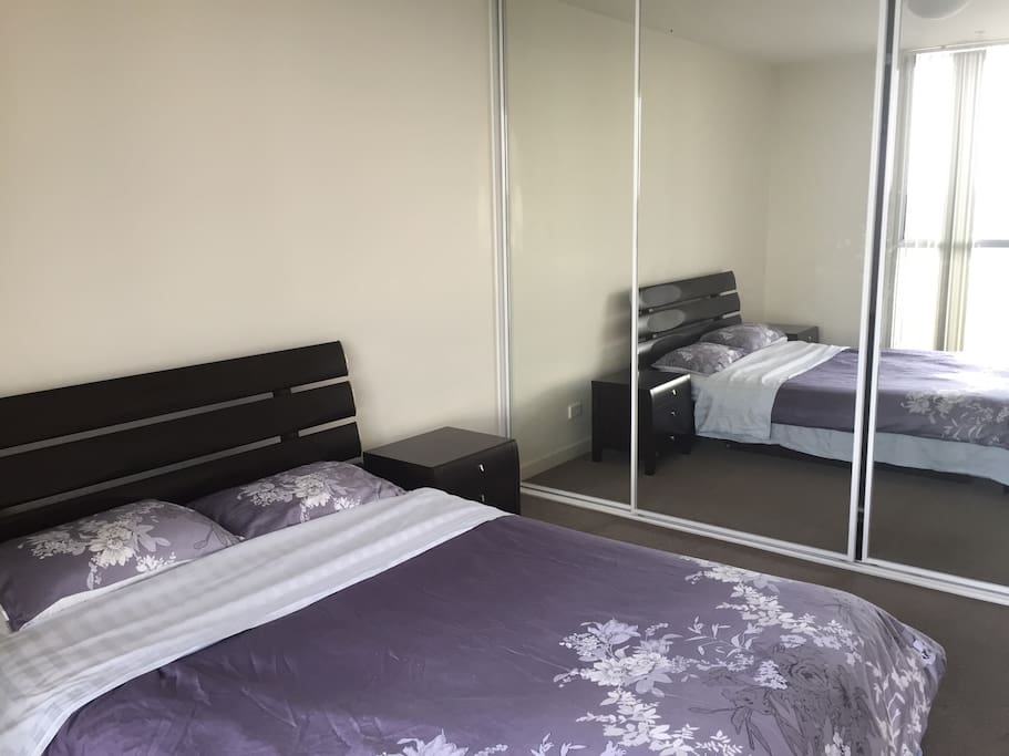 Main Bedroom with queen size bed, bedside tables and built in wardrobe