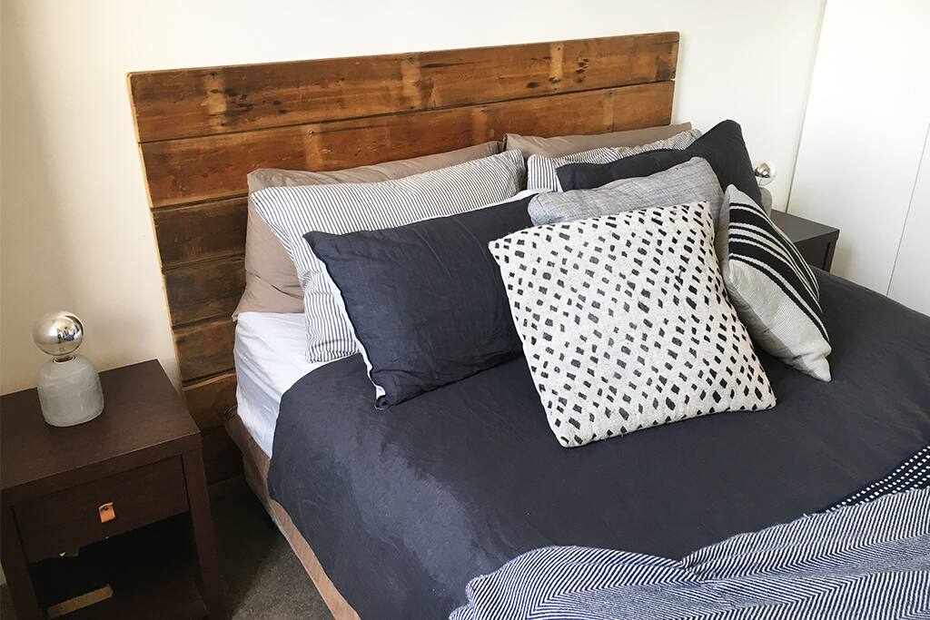 The bed features lush bedding and memory foam mattress topper