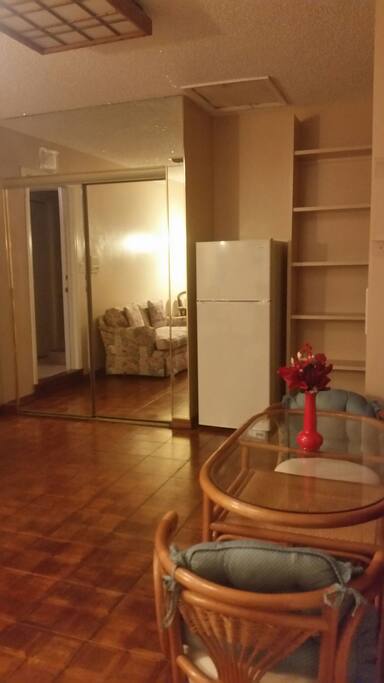 Closet with mirror sliding doors. Lots of shelving on the right, fridge, microwave provided. Small Coffee pot. Electric grill, toaster oven, double burner. Wood flooring.